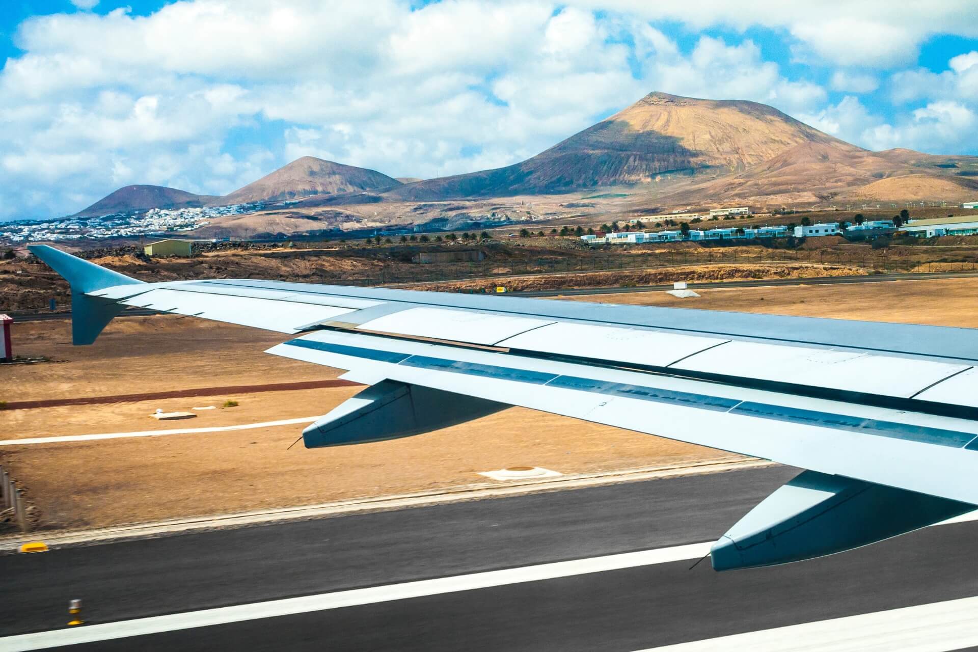 plane landing at lanzarote airport with view of landscape